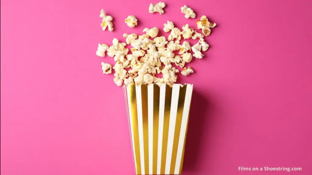 pop up cinema statistics shown with a carton of popcorn against a pink screen